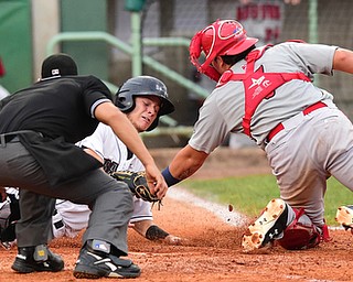NILES, OHIO - JULY 17, 2015: Connor Marabell #8 of the Scrappers is tagged out by catcher Jorge Tillero #37 of the Doubledays in the 4th inning during Friday nights game at Eastwood Field. DAVID DERMER | THE VINDICATOR.Home plate umpire David Martinez pictured.