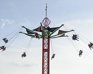 Katie Rickman | The Vindicator.From the parking lot, fairgoers can be seen flying high above the Trumbull County Fairgrounds on various rides Saturday, July 18, 2015.