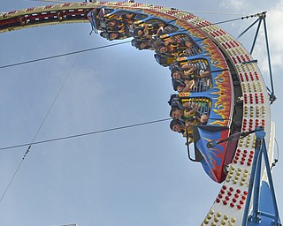 Katie Rickman | The Vindicator.Fairgoers scream and laugh as they ride the "Fire Ball" ride at the Trumbull County Fairgrounds on Saturday on July 18, 2015.