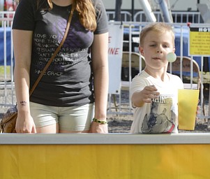 Katie Rickman | The Vindicator.Alexis Herrick 16 of Canfield and her brother Timothy 7 play a carnival game, winning a golf fish at the Trumbull County Fairgrounds on various rides Saturday, July 18, 2015.