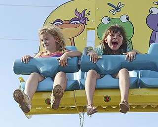 Katie Rickman | The Vindicator.Best friends Brenna Kathleen 4 on left and Taylor Dean 5 scream and laugh as they ride the "Frog Hopper" ride at the Trumbull County Fairgrounds on Saturday, July 18, 2015.