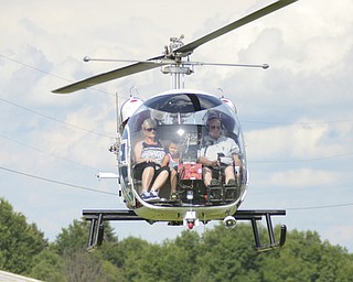 Katie Rickman | The Vindicator.Phyllis Urmson and Austin Raymond 7 both of Pittsburgh take a helicopter ride with Scibelli Helicopters at the Trumbull County Fairgrounds on Saturday, July 18, 2015.
