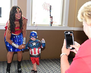 WARREN, OHIO - JULY 19, 2015: Donna Belko of Hermitage takes a picture of her grandson Dominic Gottuso 2, with Roseanne McCracken of Warren who is dressed as Wonder Woman Sunday morning at the Hippodrome ballroom during a Superhero experience event. DAVID DERMER | THE VINDICATOR..