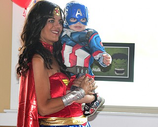 WARREN, OHIO - JULY 19, 2015: Dominic Gottuso 2, of Hermitage with Roseanne McCracken of Warren who is dressed as Wonder Woman Sunday morning at the Hippodrome ballroom during a Superhero experience event. DAVID DERMER | THE VINDICATOR.