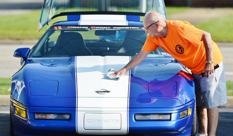 Jeff Lange | The Vindicator  JULY 19, 2015 - Elmer Swearing of New Cumberland, West Virginia polishes the hood of his 1996 Corvette Grand Sport prior to Sunday's car show in Austintown. This model is one of only 1,000 car manufactured by Chevrolet, with each sporting the exact same paint job.