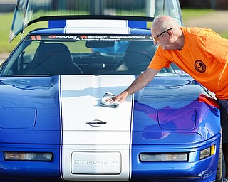 Jeff Lange | The Vindicator  JULY 19, 2015 - Elmer Swearing of New Cumberland, West Virginia polishes the hood of his 1996 Corvette Grand Sport prior to Sunday's car show in Austintown. This model is one of only 1,000 car manufactured by Chevrolet, with each sporting the exact same paint job.