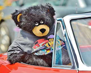 Jeff Lange | The Vindicator  JULY 19, 2015 - A black teddy bear hangs out of the passengers seat of a 1964 convertible Corvette Stingray during Sunday's car show in Austintown.