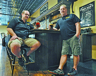Owners of Brewtus Brewing Co. Jason Camerlengo (left) and John LaRocca sit at the bar on
the first floor of their location in Sharon, Pa.