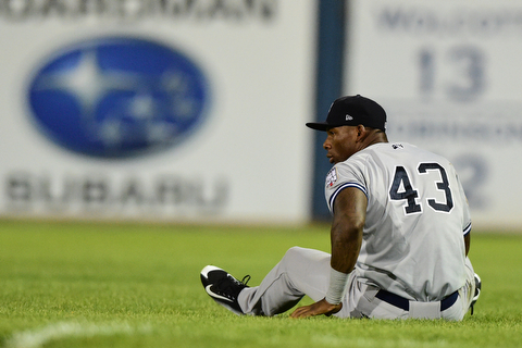 NILES, OHIO - JULY 22, 2015: Right fielder Jhalan Jackson #43 of the Yankees sits on the turf after colliding with the second basemen allowing the ball to drop and the Scrappers to win the game in the 12th inning of Wednesday nights game at Eastwood Field. DAVID DERMER | THE VINDICATOR