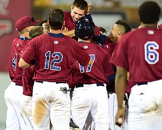 NILES, OHIO - JULY 22, 2015: Jodd Carter #11 of the Scrappers is mobbed by his teammates after the game winning hit in the 12th inning of Wednesday nights game at Eastwood Field. DAVID DERMER | THE VINDICATOR
