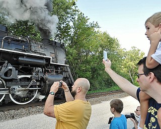 Jeff Lange | The Vindicator  JULY 25, 2015 - Admiring the vintage train from his father's shoulders is 6 year old Connor Biehl of Naples, Florida (top) prior to boarding the train for a trip to Ashtabula, Saturday morning in Youngstown. The ride on the 1944 steam-powered locomotive was a birthday gift from his parents Greg and Libby Biehl.
