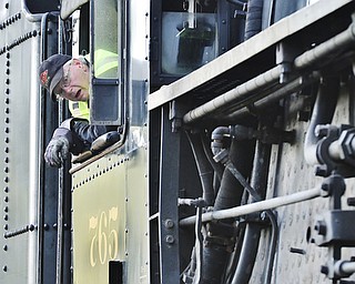 Jeff Lange | The Vindicator  JULY 25, 2015 - Rich Melvin, engineer of the Nickel Plate Road No. 765 leans out the window of the vintage locomotive, Saturday morning in Youngstown.