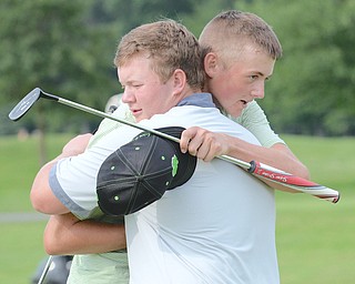 Joey Shushok of Austintown Fitch (front) embraces Ken Keller of Cardinal Mooney after their round in the Greatest Golfer of the Valley junior championship on Sunday at Avalon Lakes Golf & Country Club. Shushok held of Keller to win the 17-U title.