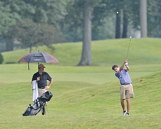 Jeff Lange | The Vindicator  JULY 26, 2015 - Jacob Wilson of Kennedy Catholic High School hits an approach shot in the rain during Sunday's Greatest Golfer of the Valley Junior championship held at Avalon Lakes Golf & Country Club in Howland.
