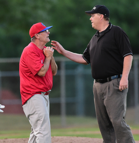 STRUTHERS, OHIO - JULY 31, 2015: Base umpire Brian Finnegan and manager Doug Garis of Charters Valley dispute after a tag up call that ended the inning and took two runs off the board in the 2nd inning during Friday nights PONY tournament game at Cene Park. DAVID DERMER | THE VINDICATOR