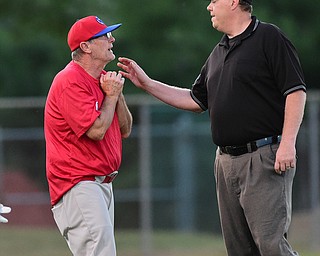 STRUTHERS, OHIO - JULY 31, 2015: Base umpire Brian Finnegan and manager Doug Garis of Charters Valley dispute after a tag up call that ended the inning and took two runs off the board in the 2nd inning during Friday nights PONY tournament game at Cene Park. DAVID DERMER | THE VINDICATOR