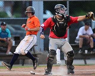 STRUTHERS, OHIO - JULY 31, 2015: Riley Campbell #6 of Youngstown Cene scores a run in the 3rd inning during Friday nights PONY tournament game at Cene Park. DAVID DERMER | THE VINDICATOR..Catcher Mason Prickett #74 pictured.