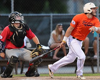 STRUTHERS, OHIO - JULY 31, 2015: Greg Popatak #17 of Youngstown Cene leaves the batters box after hitting a triple  in the 3rd inning during Friday nights PONY tournament game at Cene Park. DAVID DERMER | THE VINDICATOR...Catcher Mason Prickett #74 pictured.