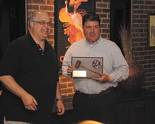 SPECIAL TO THE VINDICATOR
Kevin Freisen, right, recently received a president’s plaque and gavel from Tom Baringer, left, at the Struthers Rotary’s annual Presidents Dinner, which took place at the Springfield Grille in Boardman. Incoming President Drew Hirt discussed goals for the coming year.