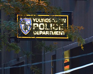 The Youngstown Police Department sign lights up the darkening road on Boardman Street.