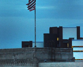 A flag blows in the wind on top of the YBI building which once was The Vindicator.