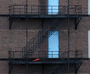 Cities are notorious for fire escapes leading to the ground below from stories high. A building off of Boardman Street is featured here.