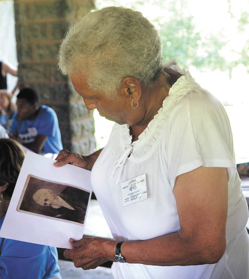 Katie Rickman | The Vindicator:  Joann Armes of Pittsburgh looks at an old photograph of Edward Howard, whose son Charles Howard, according to family members, is the namesake of Howard Street in Salem. Joann celebrated with roughly 65 relatives when they gathered in Salem.