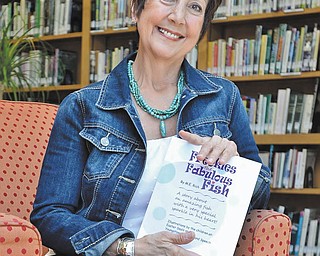 JEFF LANGE | THE VINDICATOR
Children’s author Mariellen Rich of Girard holds a copy of her inspirational book titled “Freckles the Fabulous Fish,” which she says opens children’s hearts to the possibilities of achieving goals and overcoming challenges.