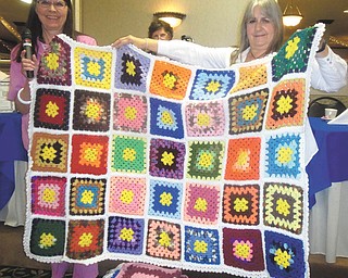 SPECIAL TO THE VINDICATOR
Trumbull retired teachers Marilyn Stanton, left, and Carol Hart are holding up a quilt created by Lynn Valentino, who used yarn donated by members of Trumbull Retired Teachers Association. TRTA then donated the quilt to a local shelter. The next meeting of TRTA will be at noon Tuesday at Ciminero’s in Niles. Burton Cole, humorist and The Tribune Chronicle editor, will be the speaker. Those who want to attend should send $11.25 to Ellen King, 7141 Vineland Place, Youngstown, OH 44512-4845.