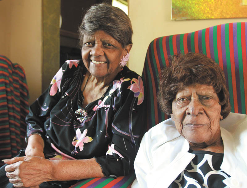Mary Johnson, 103, right, is seated with her younger sister, Jessie Washington, 101, at Johnson’s Youngstown home. The two centenarian sisters, who recently celebrated their birthdays together, are the sole survivors of 12 siblings. WILLIAM D. LEWIS | THE VINDICATOR