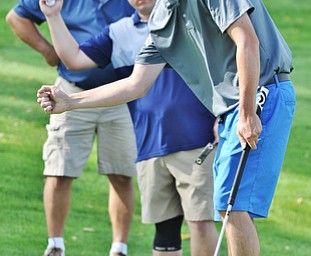 Brian Haynam of Cortland celebrates his putt for birdie as his teammates Russ Shuttleworth of Girard and Rob Davies of Champion look on from behind during Monday afternoon's Greatest golfer of the Valley scramble at the Lake Club in Poland.