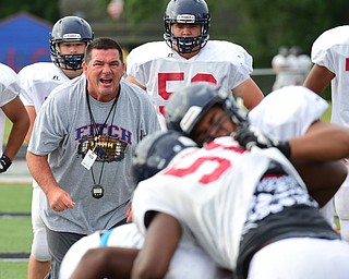AUSTINTOWN, OHIO - AUGUST 11, 2015: Offense line coach Doug Barnhard of Fitch shots instructions during a blocking drill Tuesday morning during a preseason practice at Fitch High School. DAVID DERMER | THE VINDICATOR