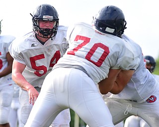 AUSTINTOWN, OHIO - AUGUST 11, 2015: Nick Bush #54 of Fitch runs before assisting a teammate with blocking Evan Shobel #70  during a preseason practice at Fitch High School. DAVID DERMER | THE VINDICATOR