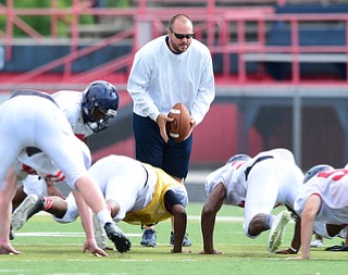 AUSTINTOWN, OHIO - AUGUST 11, 2015: Outside linebackers coach Joe McMahon instructs the kids to do a up down during a defensive pursuit drill during a preseason practice at Fitch High School. DAVID DERMER | THE VINDICATOR