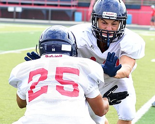 AUSTINTOWN, OHIO - AUGUST 11, 2015: oey Zielinski #12 of Fitch takes not he block from Randy Smith #25 during a defensive back drill Tuesday morning during a preseason practice at Fitch High School. DAVID DERMER | THE VINDICATOR
