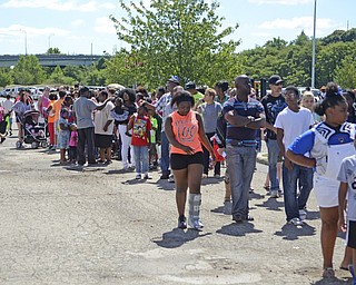 Katie Rickman | The Vindicator.A line forms before the backpack giveaway where 2,000 bags were given out to local children at Covelli Centre August 24, 2015. The event was a collaborated effort by the city of Youngstown, city schools, and NOW Youngstown.