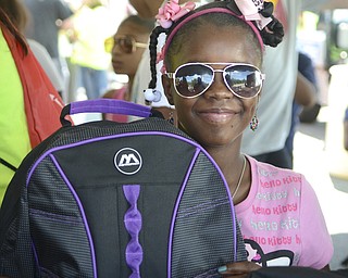 Katie Rickman | The Vindicator.Allayah Green 11 smiles as she holds up her new backpack that she will use this year as she begins her school year at Williamson Elementary School. Green was one of many who attended  the community wide back-to-school backpack giveaway at the Covelli Centre August 24, 2015. The event was a collaborated effort by the city of Youngstown, city schools, and NOW Youngstown.