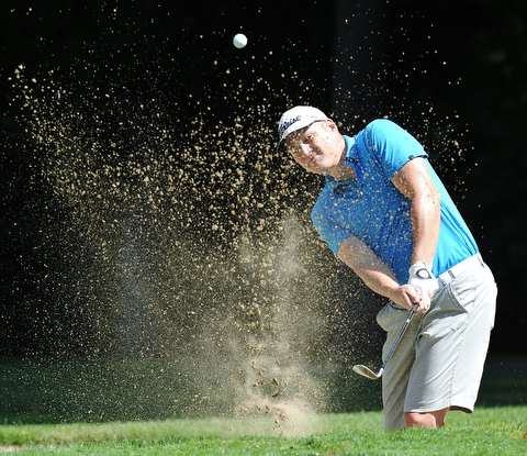 Jeff Lange | The Vindicator  AUGUST 22, 2015 - Keith Schubert of Girard looks through a wall of sand as he blasts his way out of the No. 5 bunker during Saturday's Greatest Golfer of the Valley tournament held at Youngstown Country Club.