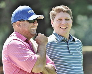 Jeff Lange | The Vindicator AUGUST 23, 2015 - Jonah Karzmer of Poland (right) shares a laugh with his caddy Marc Jakubovic of Poland during a break in the action on the first hole during Sunday's Greatest Golfer of the Valley tournament held at the Lake Club in Poland.