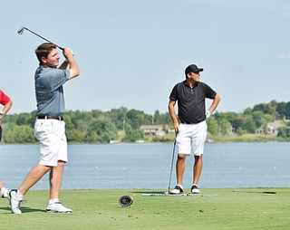 Jeff Lange | The Vindicator AUGUST 23, 2015 - Jonah Karzmer of Poland (center), Michael Porter (left) and Scott Porter look on at Karzmer's tee shot late in the Greatest Golfer tournament held at the Lake Club in Poland, Sunday afternoon.