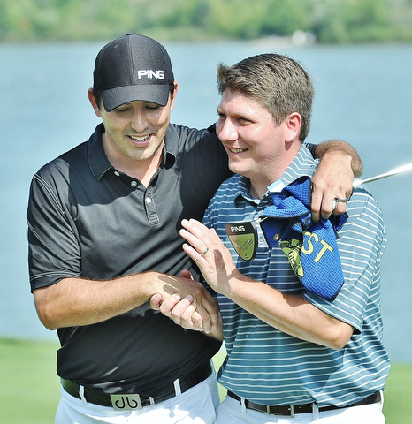 Jeff Lange | The Vindicator  AUGUST 23, 2015 - Upon winning the Pete Mollica's Open Division of the Greatest Golfer tournament, Jonah Karzmer of Poland (right) is congratulated with a hug and a handshake from competitor Scott Porter of Poland, Sunday afternoon at the Lake Club in Poland. Karzmer won by five strokes with a final score of 213.