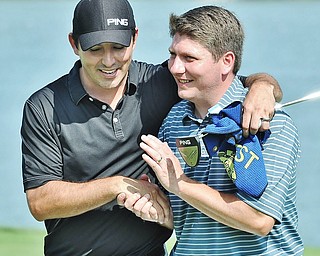 Jeff Lange | The Vindicator AUGUST 23, 2015 - Upon winning the Pete Mollica's Open Division of the Greatest Golfer tournament, Jonah Karzmer of Poland (right) is congratulated with a hug and a handshake from competitor Scott Porter of Poland, Sunday afternoon at the Lake Club in Poland. Karzmer won by five strokes with a final score of 213.
