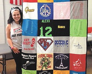 SPECIAL TO THE VINDICATOR
Alexx Hames, alumna of the Western Reserve Rangers 4-H Club, shows off the quilt she made from T-shirts she collected while a high school student at Western Reserve.