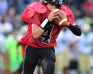 YOUNGSTOWN, OHIO - AUGUST 28, 2015: Quarterback James Boatwright III #4 of East rolls out to pass during the 1st half of a game Friday night at Rayen Stadium. DAVID DERMER | THE VINDICATOR