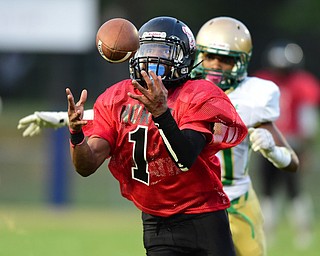 YOUNGSTOWN, OHIO - AUGUST 28, 2015: Defensive back Imoni Donadelle #1 of East intercepts a pass intended for Dawalyn Washington #10 of Ursuline during the 1st half of a game Friday night at Rayen Stadium. DAVID DERMER | THE VINDICATOR