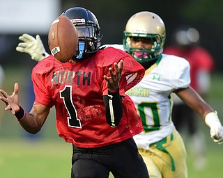 YOUNGSTOWN, OHIO - AUGUST 28, 2015: Defensive back Imoni Donadelle #1 of East intercepts a pass intended for Dawalyn Washington #10 of Ursuline during the 1st half of a game Friday night at Rayen Stadium. DAVID DERMER | THE VINDICATOR