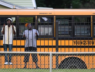 YOUNGSTOWN, OHIO - AUGUST 28, 2015: Spectators watch the game through the fence outside of Rayen Stadium during the 1st half of a game between East and Ursuline on Friday night at Rayen Stadium. DAVID DERMER | THE VINDICATOR