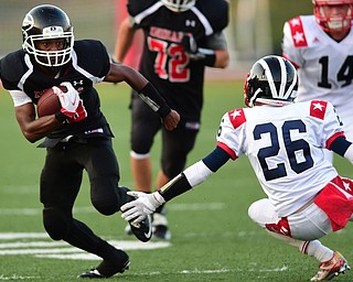 GIRARD, OHIO - AUGUST 27, 2015: Receiver Collin Harden #39 of Girard runs upfield after sidestepping defensive back Garrett Pitts #26 of Niles during the 1st half of their football game Thursday night at Arrowhead Stadium. DAVID DERMER | THE VINDICATOR