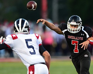 GIRARD, OHIO - AUGUST 27, 2015: Quarterback Mark Waid #7 of Girard throws a pass before Rich Limongi #5 of Niles could get a hit on him during the 1st half of their football game Thursday night at Arrowhead Stadium. DAVID DERMER | THE VINDICATOR
