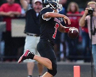 GIRARD, OHIO - AUGUST 27, 2015: Quarterback Mark Waid #7 of Girard celebrates while sprinting into the end zone to score a touchdown during the 1st half of their football game Thursday night at Arrowhead Stadium. DAVID DERMER | THE VINDICATOR